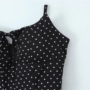 Polka dot camisole top with thin neck straps and decorative bow knot detail