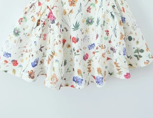 Detailed view of floral dress fabric featuring colorful botanical prints and butterfly motifs