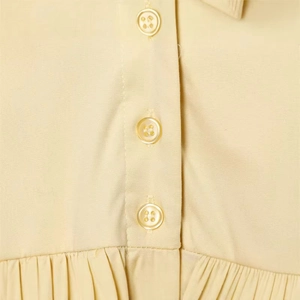 Pale yellow poplin mini dress featuring a classic collar and elegant button-down detail