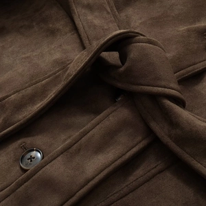 Macro shot of dark brown faux suede blazer with resin button and knotted waist belt detail