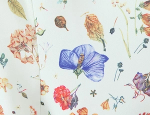 Close-up of floral print fabric showing watercolor style flowers and fine textile texture