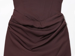 Detail of square neck dress featuring structured boning and elegant dark brown draping