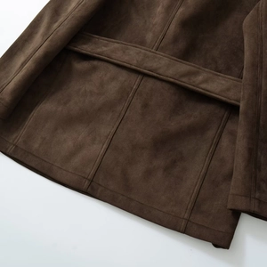 Detail of dark brown faux suede blazer showing back waist belt and precision stitching