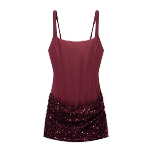 Detail of wine red corset top featuring structured boning and shimmering sequin trim