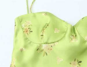 Detailed macro shot of the neon green satin floral camisole top with thin straps