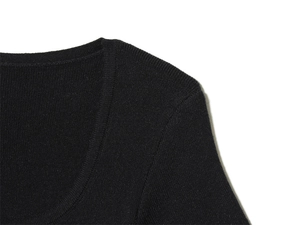 Detail of the high-quality black knitted fabric texture and U-neck stitching quality