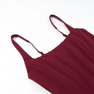 Detail of adjustable straps and corset-style stitching on a burgundy sequin dress