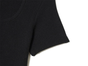 Close-up of black knitted top featuring a U-neckline and high-quality fine texture