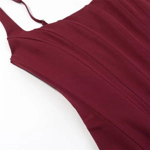 Detail of burgundy corset dress with vertical seam stitching and adjustable thin straps