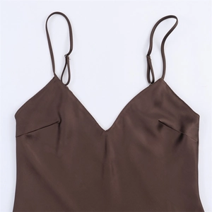 Detailed close-up of dark brown satin camisole with adjustable straps and V-neckline