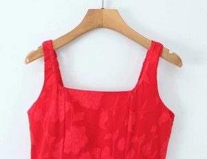 Detailed macro shot of red floral jacquard fabric and square neckline on a summer dress