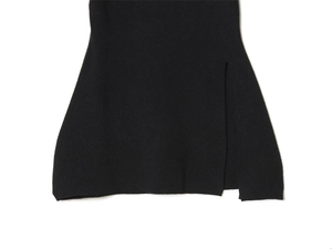 Detail view of the side slit hem on a black knit short-sleeved top for women