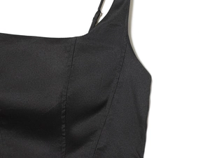 Detail of adjustable thin straps and refined stitching on a black square neck midi dress