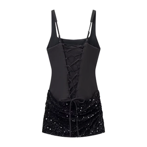 Detail of the back lace-up design and sequined fabric on this sleek black mini dress