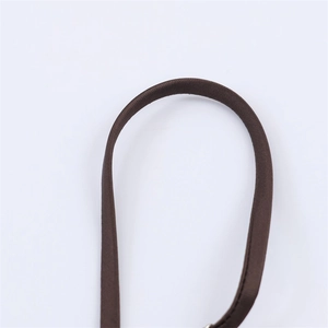 Macro view of brown satin texture and precise stitching on stylish dress detail