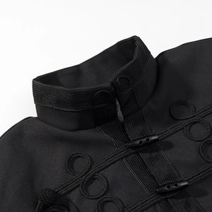 Detail of mandarin collar and traditional black knot buttons on a textured jacket