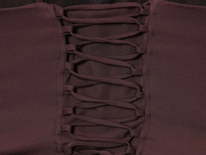 Detailed macro view of the lace-up design and knitted fabric texture on the midi dress