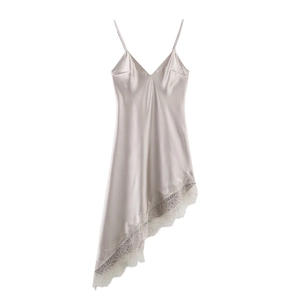 Detail view of champagne satin dress showing fine lace hem and silk-like fabric texture
