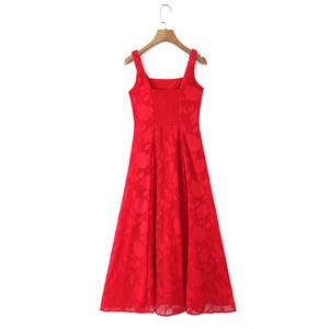 Detail of red floral jacquard fabric and smocked back design on a sleeveless midi dress