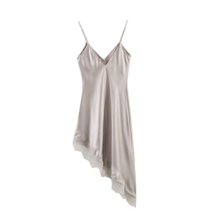 Detail of the champagne satin dress featuring delicate lace trim and asymmetrical hemline
