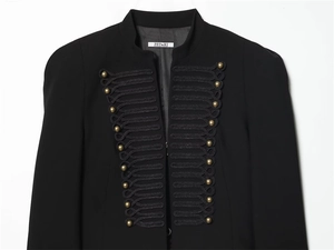 Detail of military style black jacket featuring gold dome buttons and braided trim