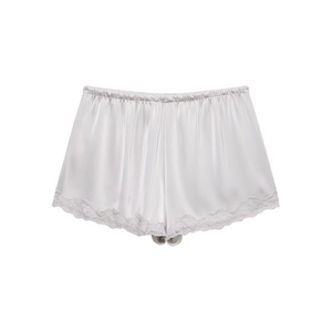 Close-up of pearl white satin shorts with delicate lace trim and elastic waistband