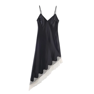 Detail view of smooth black satin dress with elegant white scalloped lace trim
