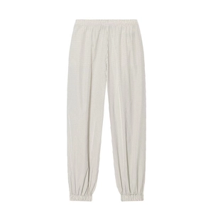 Detail of plaid patterned jogger pants featuring elastic waist and gathered cuffs