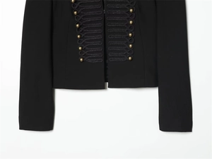 Detail of military style blazer with gold buttons and black braided decorative trim