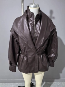 Detail of dark brown faux leather jacket featuring elastic waist and metallic silver zipper
