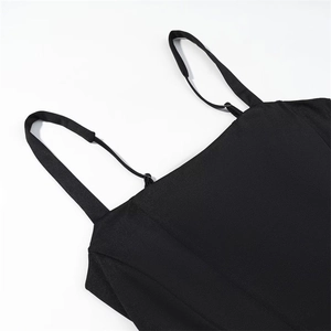 Detail shot of the sleek black spaghetti straps and smooth fabric of the modern mini dress