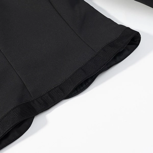 Detailed view of the ribbed cuff and high-quality stitching on a black oriental jacket
