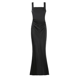Detailed close-up of black satin evening gown featuring side pleats and a fishtail hemline