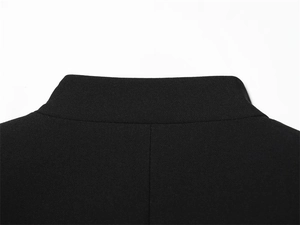 Detail of elegant black blazer collar featuring clean stitching and smooth fabric texture