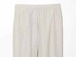 Detail shot of beige plaid trousers featuring an elastic waistband and breathable fabric