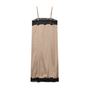 Detail of polka dot print on beige slip dress with elegant black lace trimming