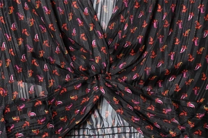 Close-up of V-neck twist detail and smocked waist on paisley chiffon blouse