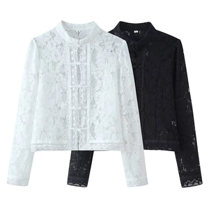 Detailed close-up of lace floral patterns and mandarin collar with frog buttons