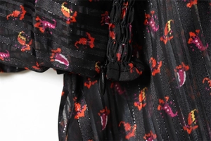 Detail of the invisible side zipper and pleats on the floral print V-neck top