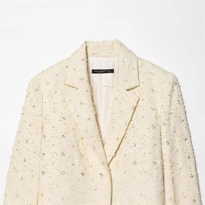 Elegant cream bouclé tweed blazer for women featuring subtle sequins and wide lapels