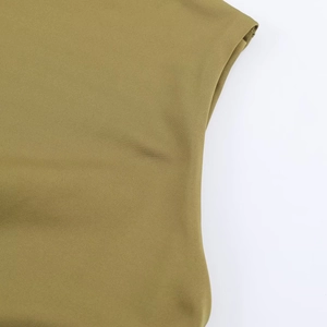 Close-up of olive green knitted fabric showing fine texture and stitching on summer dress