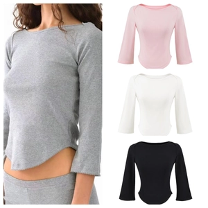 Detail of ribbed knit boat neck top featuring a curved hem in four versatile colors