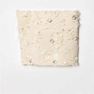 Elegant ivory cropped blazer with textured fabric, 3D floral sequins, and pearls