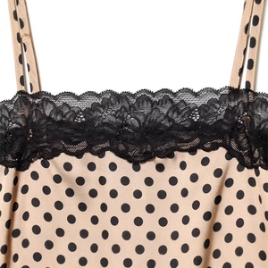 Chic beige polka dot slip dress with delicate black lace trim at the neckline