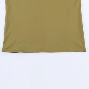 Detail view of olive green dress hem showing neat double-needle stitching and fabric texture
