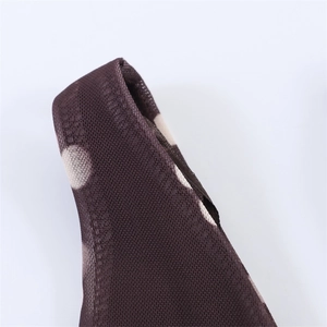 Macro detail of breathable polka dot mesh fabric and fine stitching on the shoulder strap