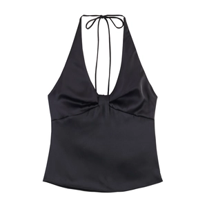 Detailed close-up of a black satin halter top with a plunging V-neck and twist-front knot detail