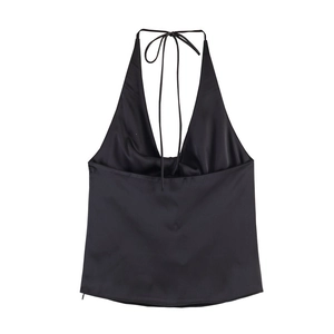 Detail of black satin halter top featuring a deep V-neck and delicate tie-neck closure