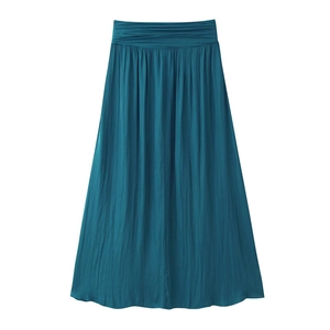 Detailed view of teal blue pleated maxi skirt featuring elastic waistband and satin texture