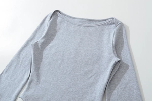 Close-up of heather grey boat neck knit top showing fine fabric texture and neckline
